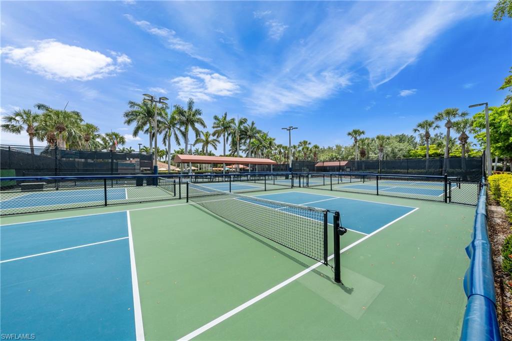 Multiple outdoor courts featuring blue and green playing surfaces, white court lines, and black perimeter fencing