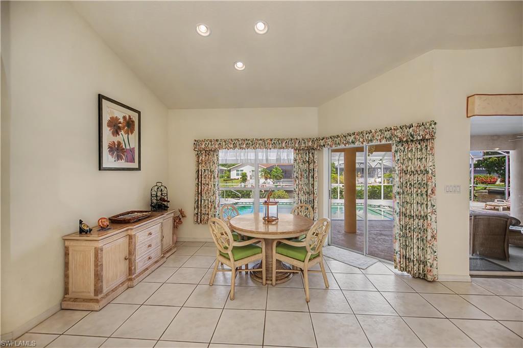 Vaulted ceilings and recessed lighting illuminate this dining area