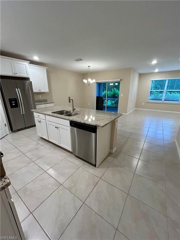 Open concept kitchen featuring an island with a built-in sink and stainless-steel appliances