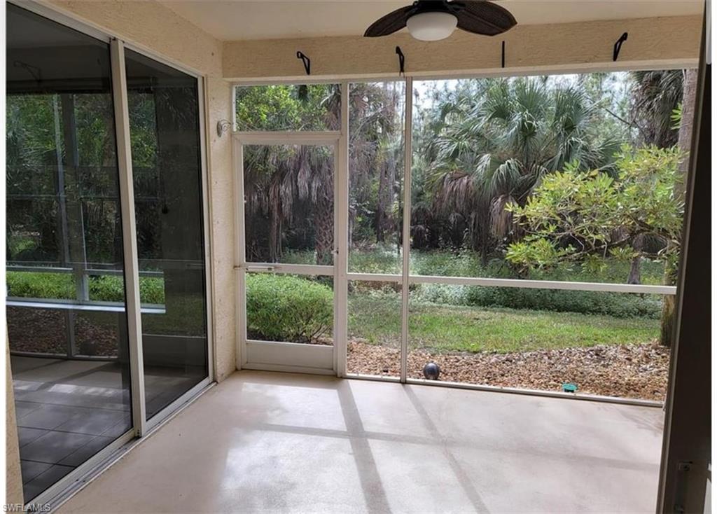 Unfurnished sunroom with ceiling fan