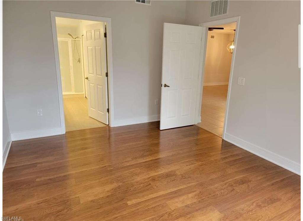 Unfurnished bedroom with hardwood / wood-style floors