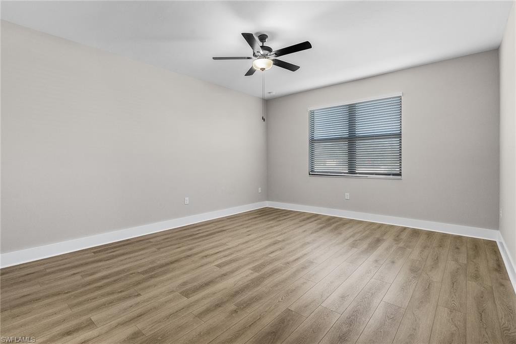 Empty room featuring light wood-style flooring and ceiling fan