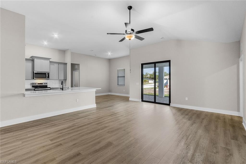 Unfurnished living room featuring light wood-style floors, ceiling fan, and recessed lighting