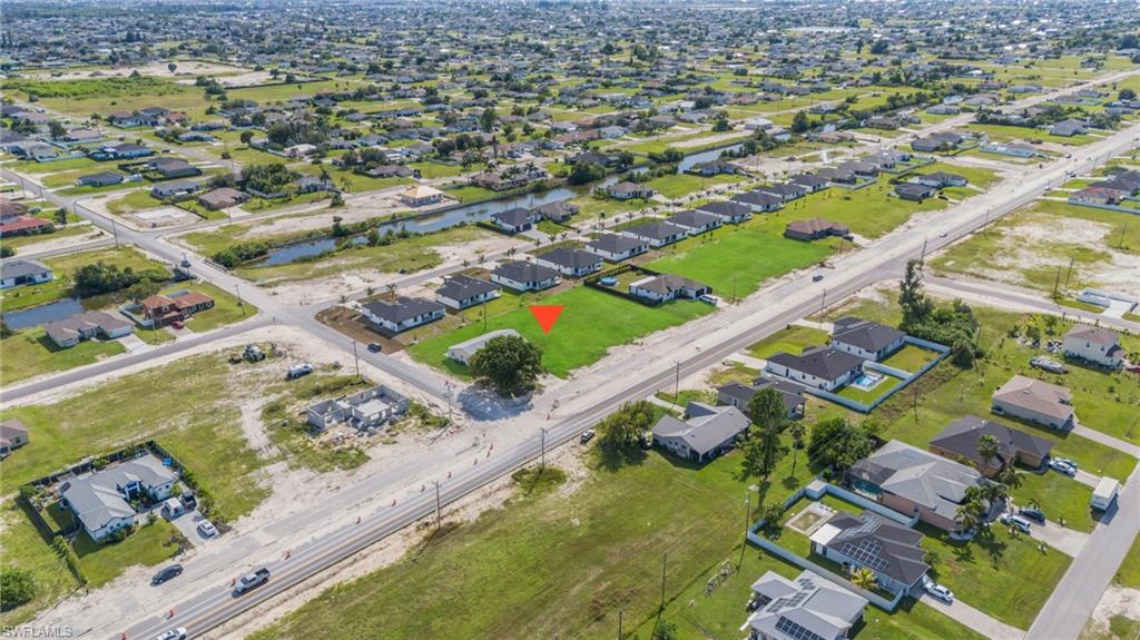 Aerial overview of property's location with a large body of water and nearby suburban area