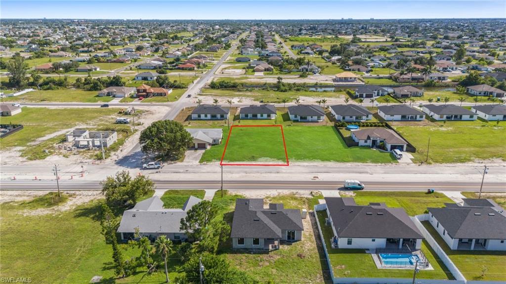 Aerial perspective of suburban area featuring property boundaries highlighted