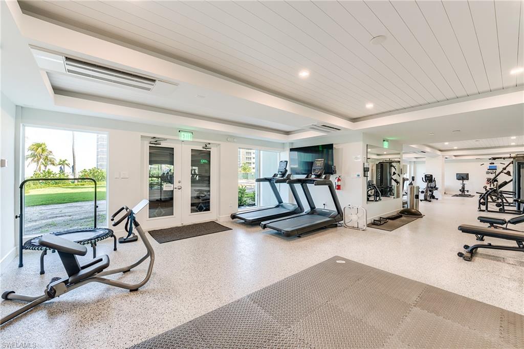 Fitness area with large windows, recessed lighting, and a white plank ceiling