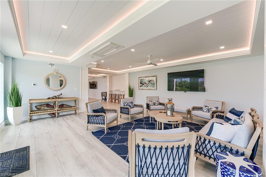 Light wood-finish flooring with a shiplap ceiling featuring recessed lighting