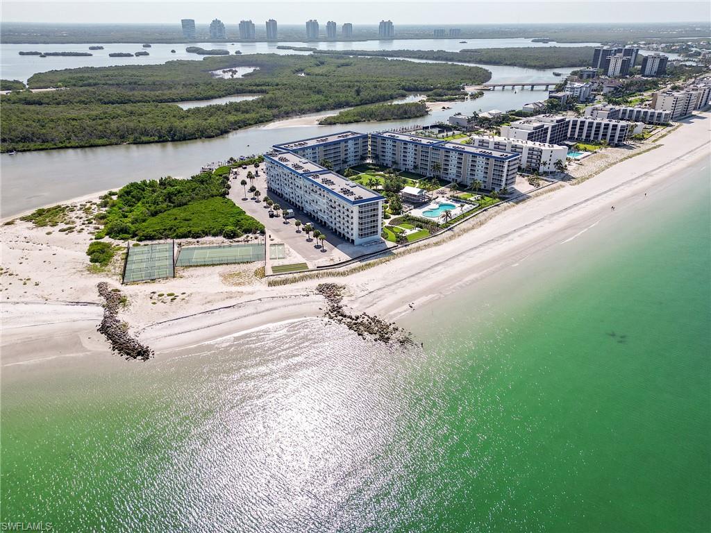 Coastal property featuring direct beach access, multiple tennis courts, and a community pool