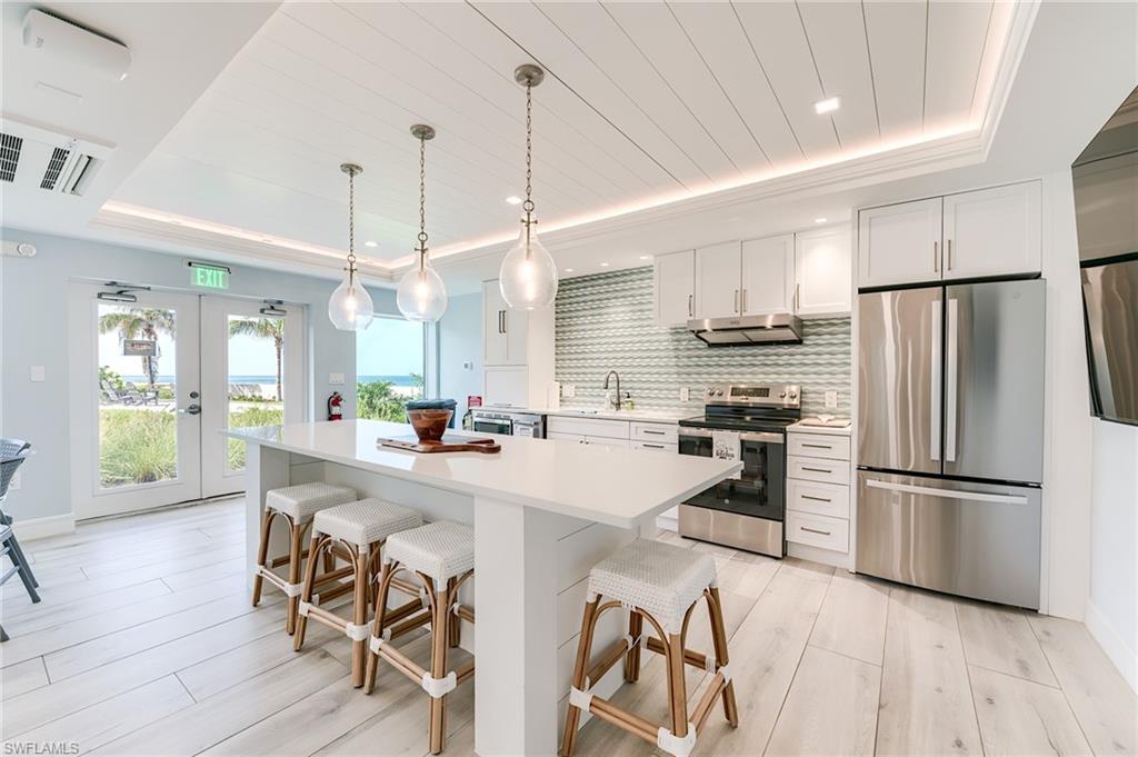 Kitchen featuring a white plank ceiling, recessed lighting, and pendant lights over the island