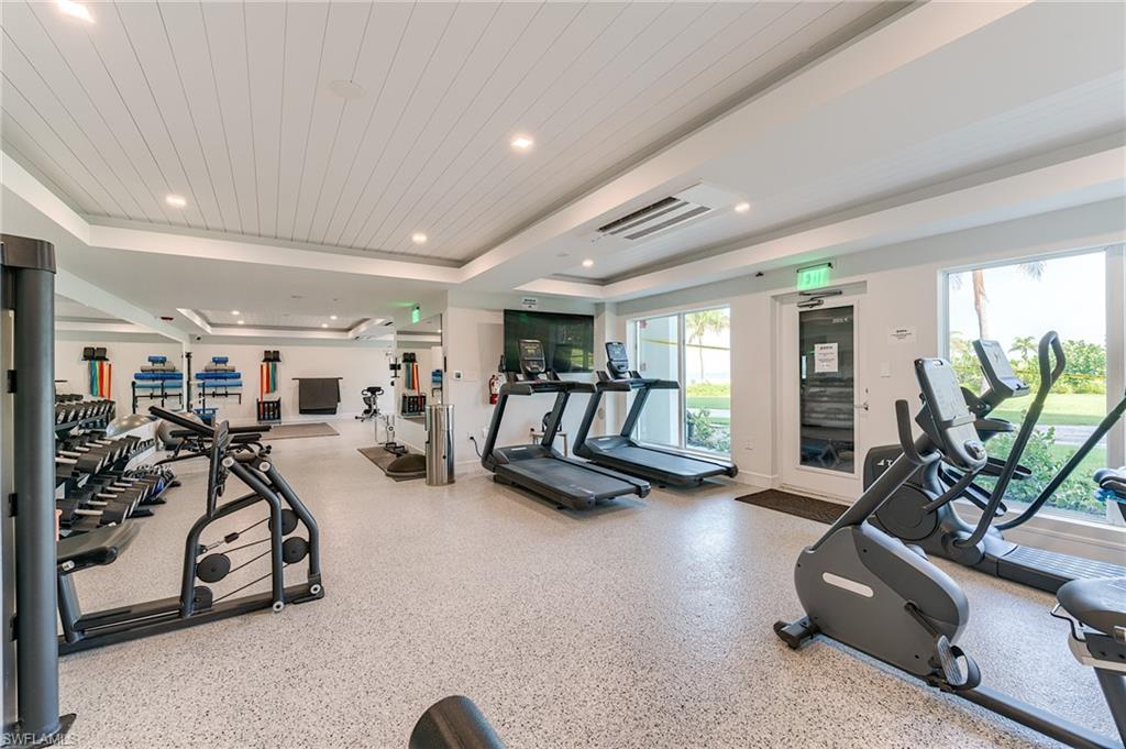 Fitness room featuring a white plank ceiling, recessed lighting, large windows, and a durable speckled floor