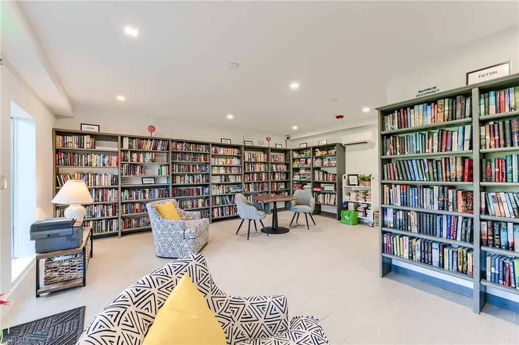 Extensive built-in shelving, recessed lighting, light-toned flooring, and a window for natural illumination