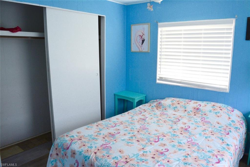 Bedroom featuring vibrant blue wall paneling