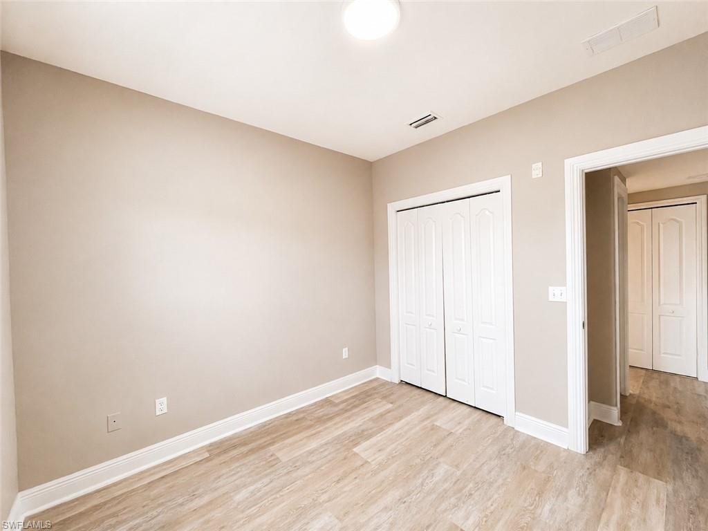 Neutral-toned room featuring wood-finish flooring