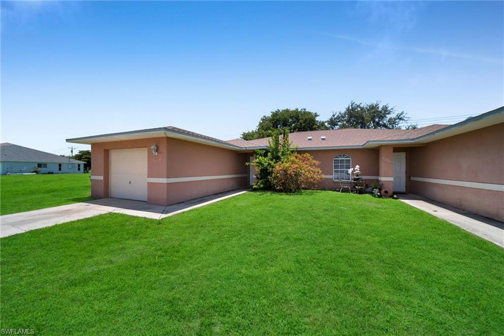 Single-story residence featuring a stucco exterior, attached garage with a concrete driveway, and a front entry door