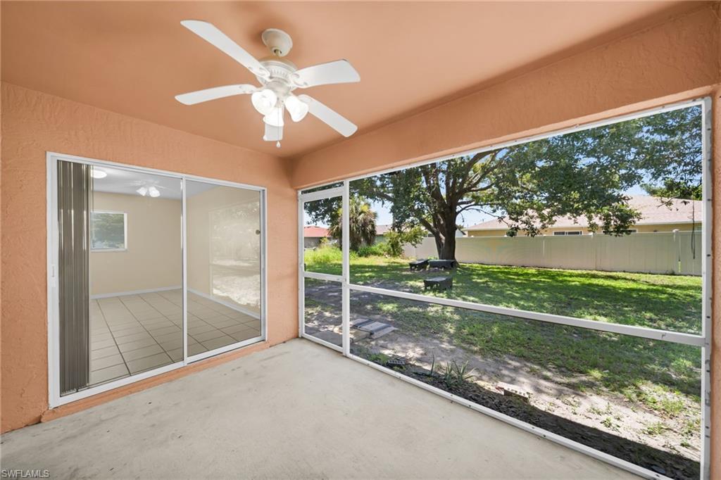 Screened patio with a white ceiling fan and concrete flooring