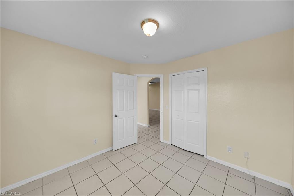 Neutral-toned walls complement the square tile flooring throughout