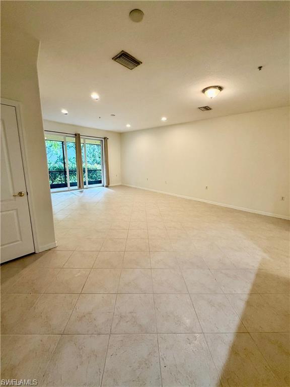 Spacious interior with tile flooring and neutral wall tones