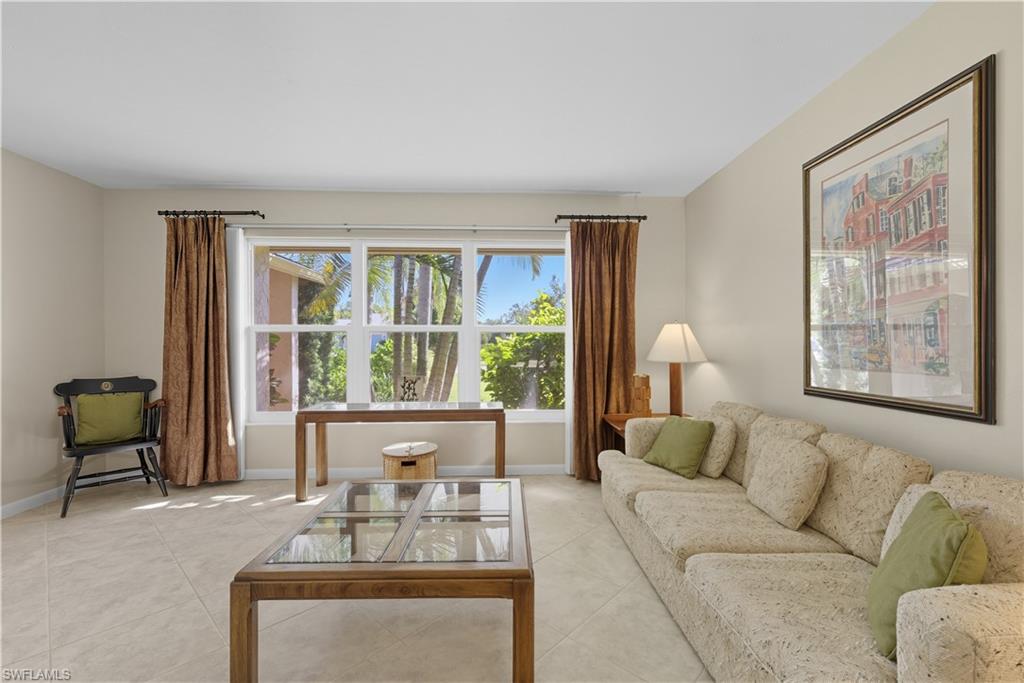 Tiled living area featuring baseboards