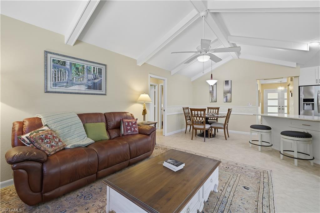 Living area with light tile patterned floors and ceiling fan