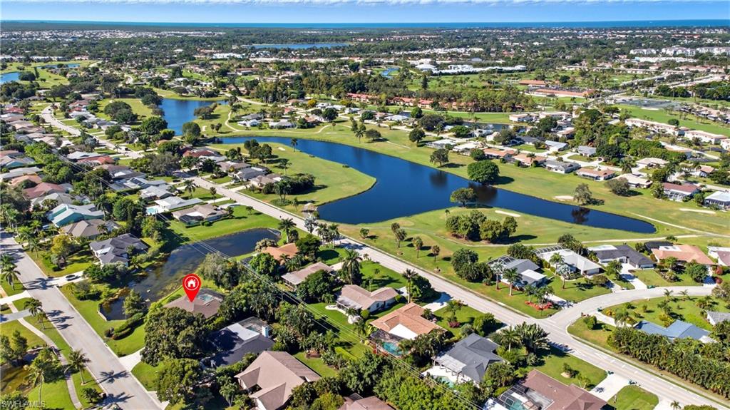 Aerial overview of property's location with nearby suburban area and a large body of water