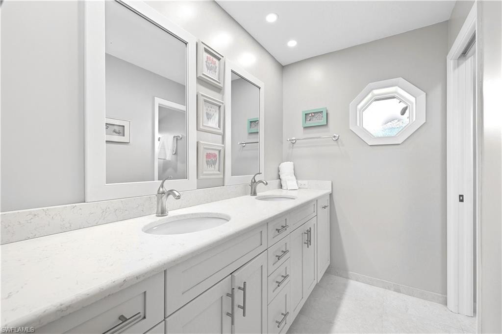 Bathroom featuring double vanity and recessed lighting