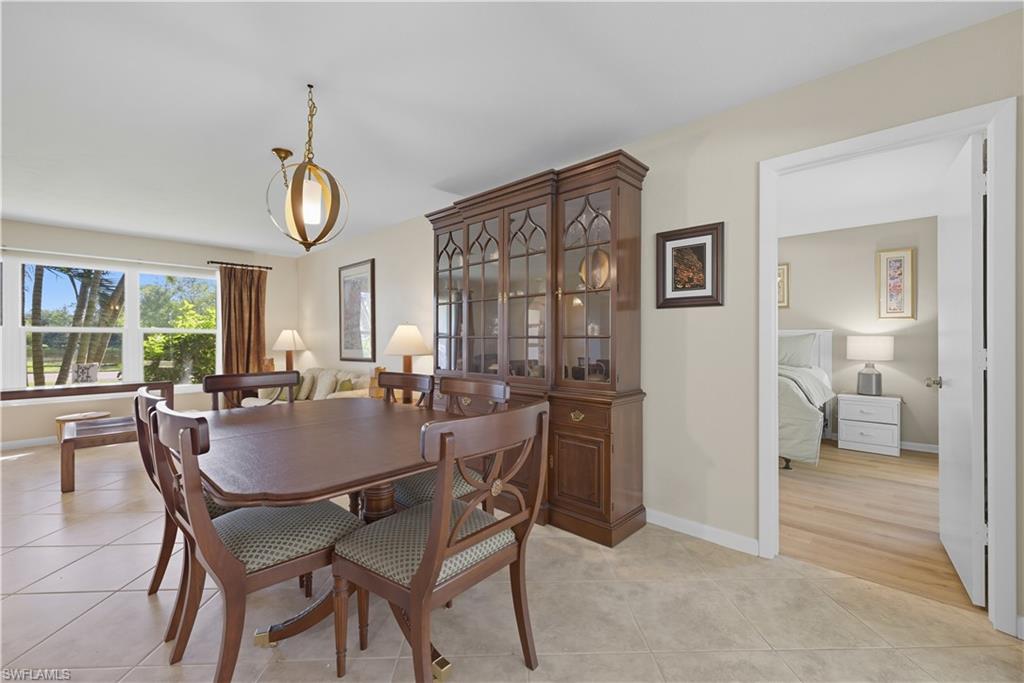 Dining area with light tile patterned floors and baseboards