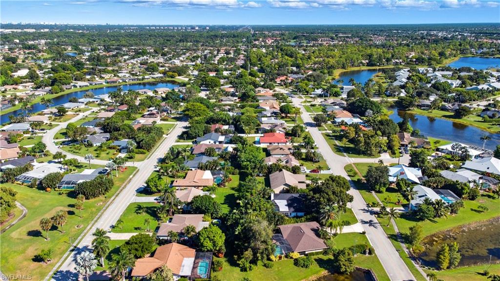 Aerial view of property's location with nearby suburban area and a nearby body of water