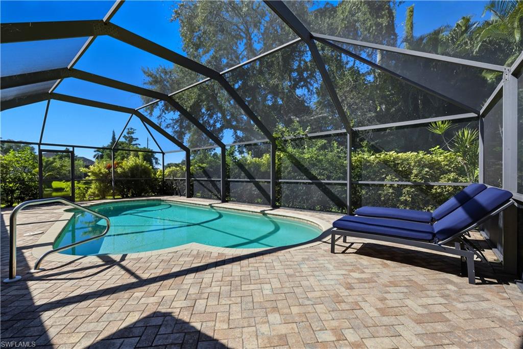 Outdoor pool with a lanai and a sunroom