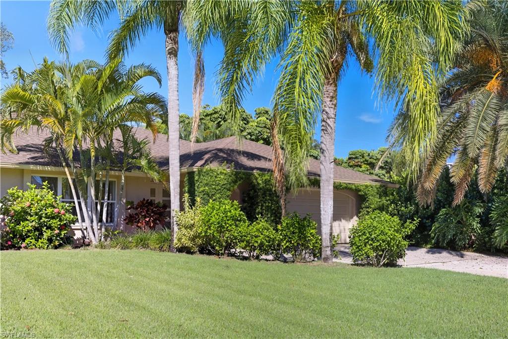 Single story home with a front lawn, an attached garage, and stucco siding