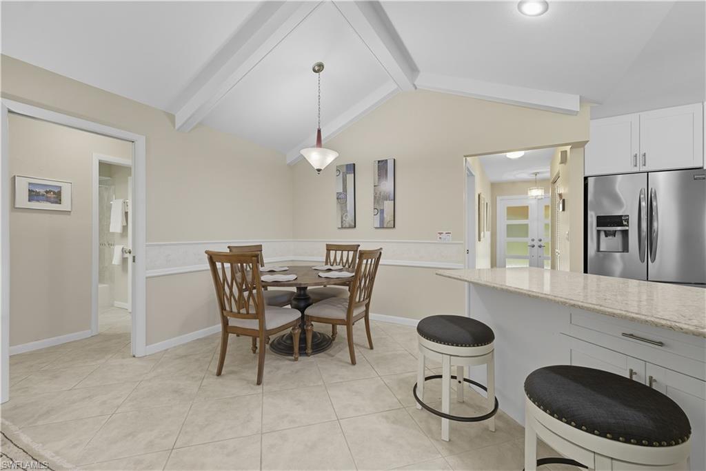 Dining room featuring light tile patterned floors and baseboards