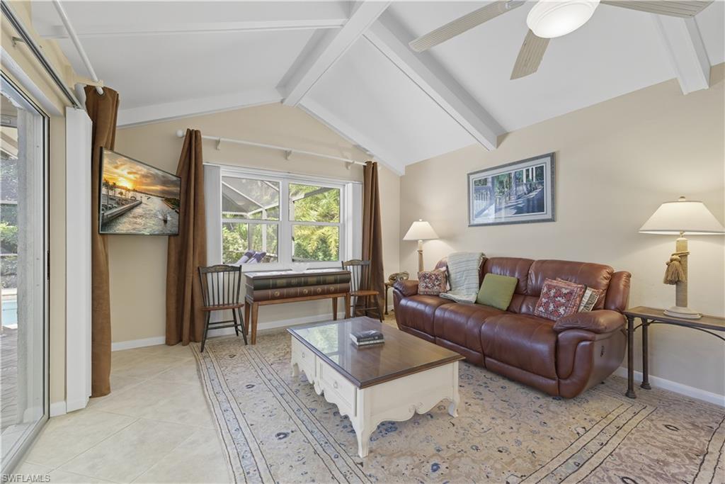Living area with ceiling fan and light tile patterned flooring