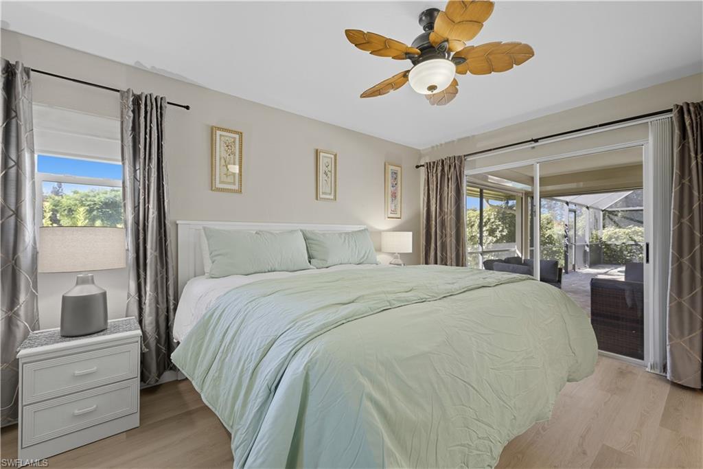 Bedroom featuring light wood-type flooring, access to outside, and a ceiling fan