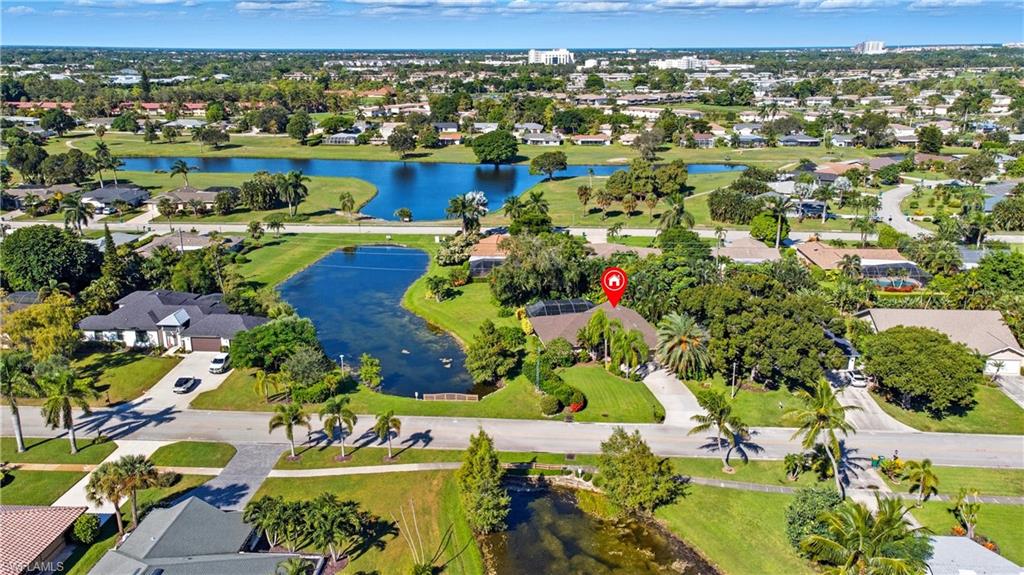 Aerial overview of property's location featuring a nearby body of water and nearby suburban area
