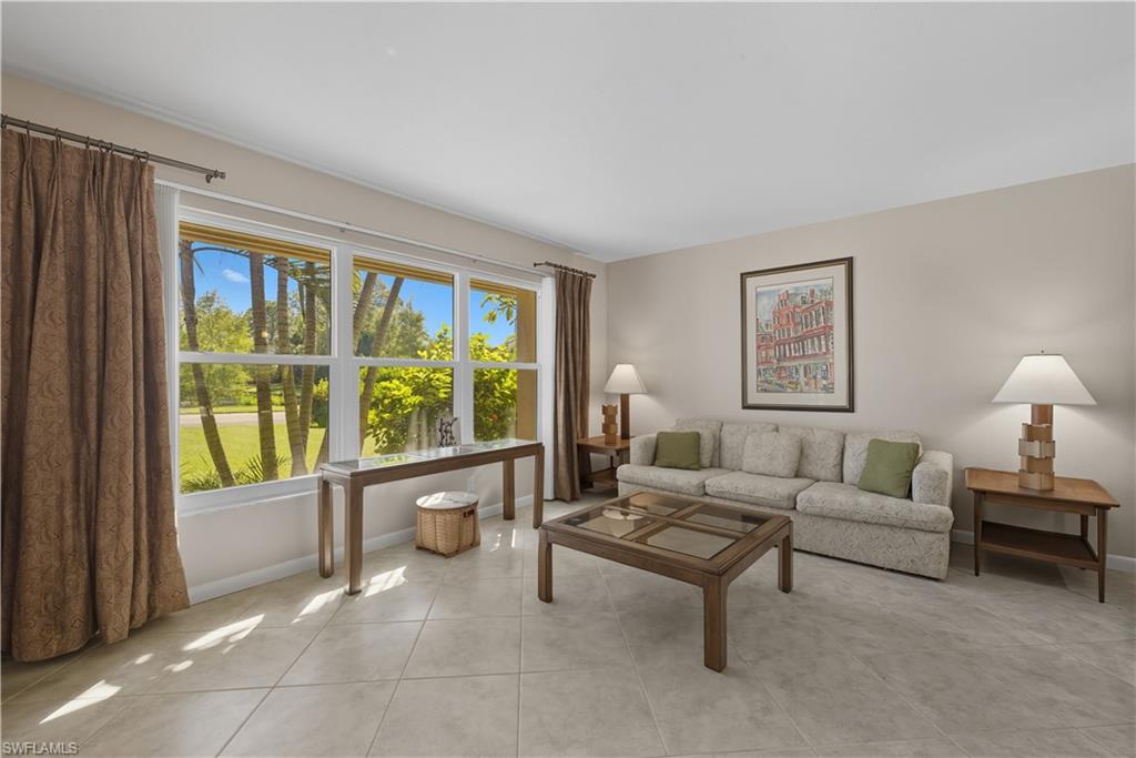 Living area featuring light tile patterned floors and baseboards