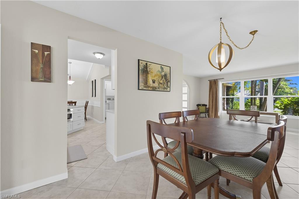 Dining space featuring light tile patterned flooring and baseboards