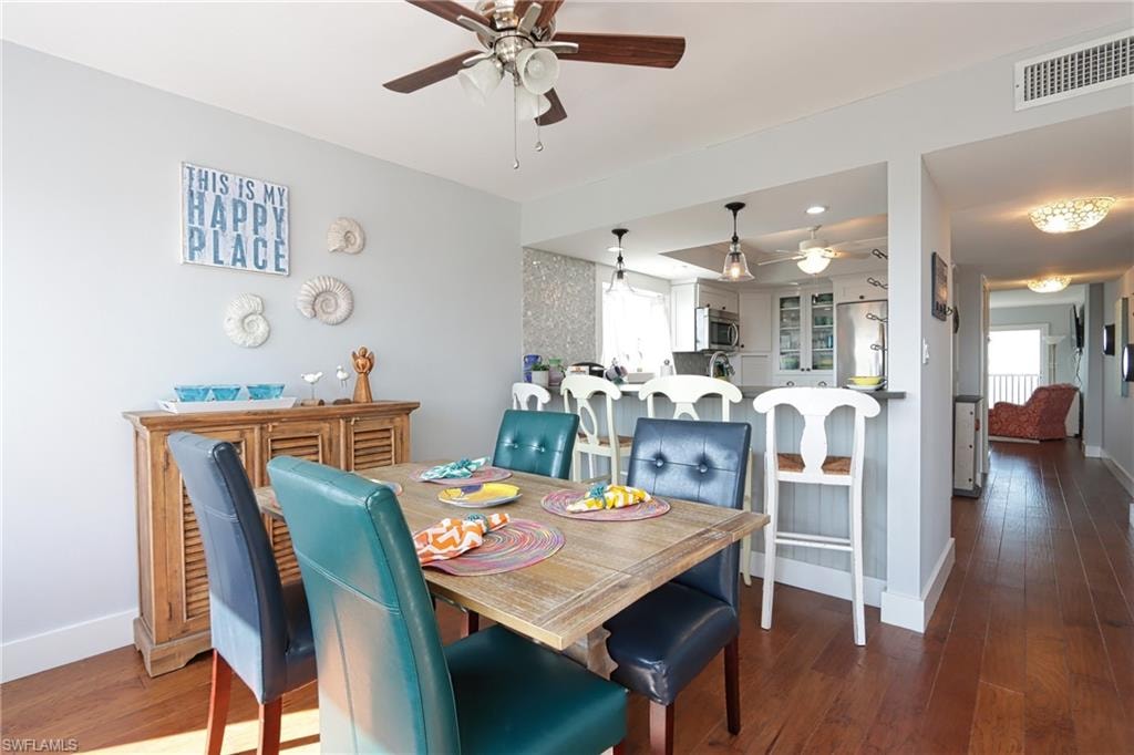 Dining space with wood-type flooring and ceiling fan