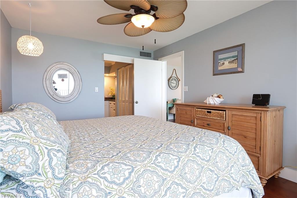 Bedroom with ceiling fan and hardwood / wood-style flooring