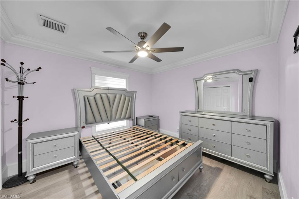 Spacious room featuring light wood-finish flooring and a ceiling fan