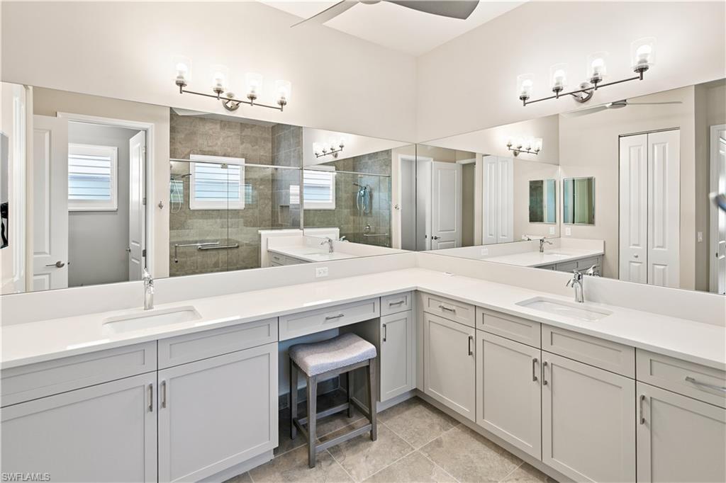 Primary Bathroom Spacious bathroom featuring an expansive vanity with double sinks, light-toned cabinetry, and ample counter space