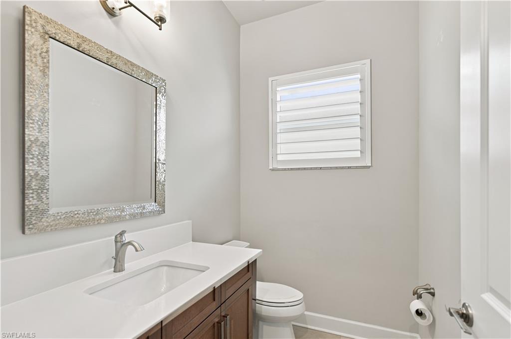 Bathroom vanity featuring a rectangular undermount sink, brushed nickel faucet, and a quartz countertop