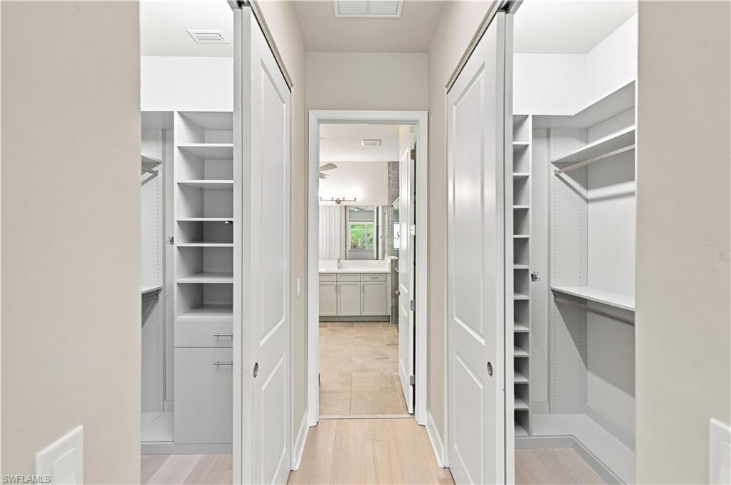 Primary Bed 2 walk in closets with organization systems built-in