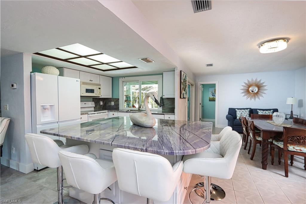 Dining space with sink and light tile floors