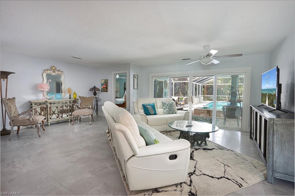Living room featuring ceiling fan and light tile floors