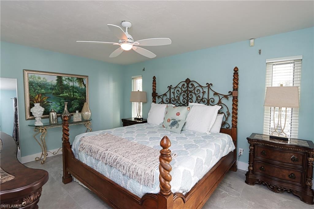 Tiled bedroom with ceiling fan