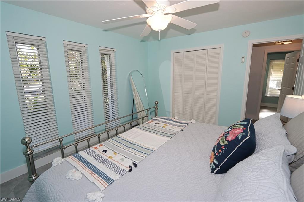 Bedroom with carpet, ceiling fan, and a closet