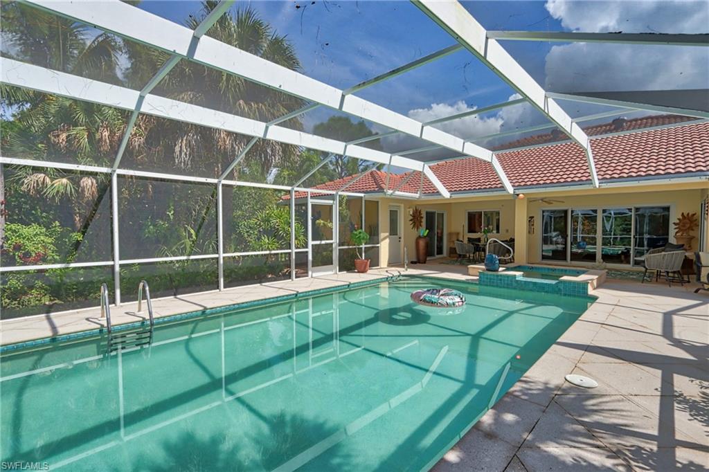 View of pool featuring a patio area, an in ground hot tub, and a lanai