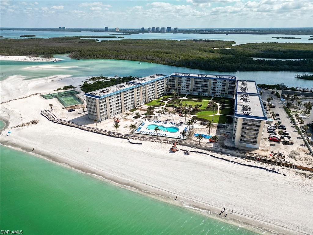 Bird's eye view of unending shoreline and apartment complex