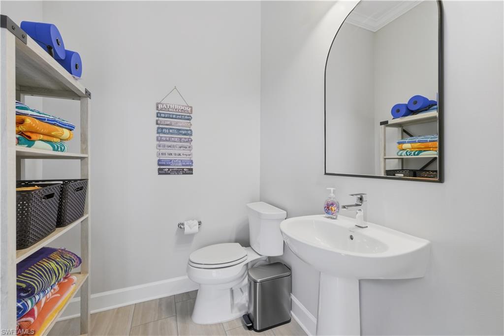 Bathroom with toilet and baseboards