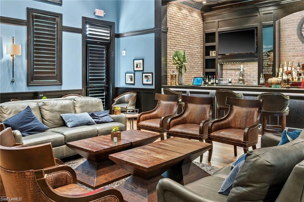 Building lobby with brick wall, a wainscoted wall, a decorative wall, and a towering ceiling