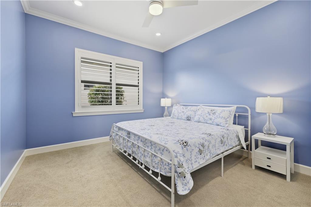 Bedroom with crown molding, light carpet, a ceiling fan, and recessed lighting